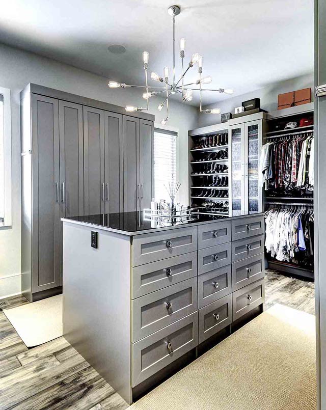 gray walk-in closet with large counter at the center