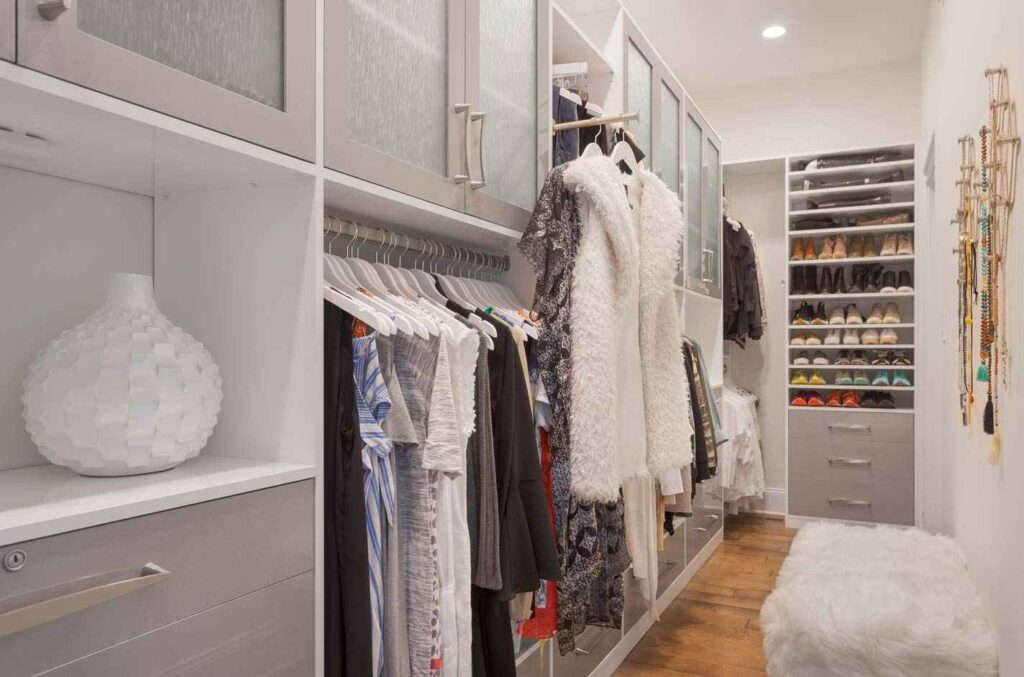 walk-in closet with clothes and shoes
